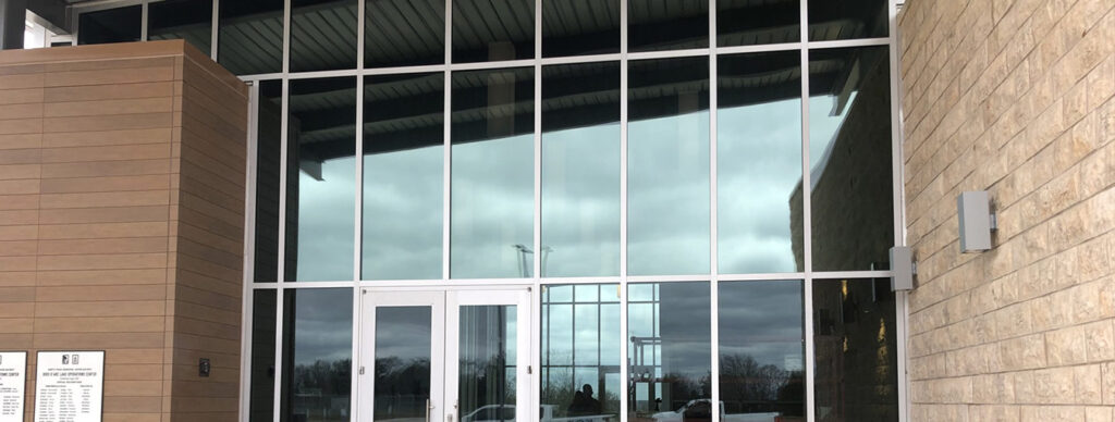commercial building with a wall of windows that are tinted